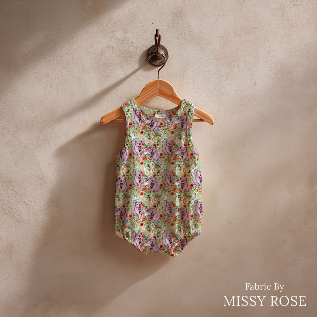Design 1002 Green Koala Fabric sewn into a baby romper – see how the print looks made up | Fabric by Missy Rose