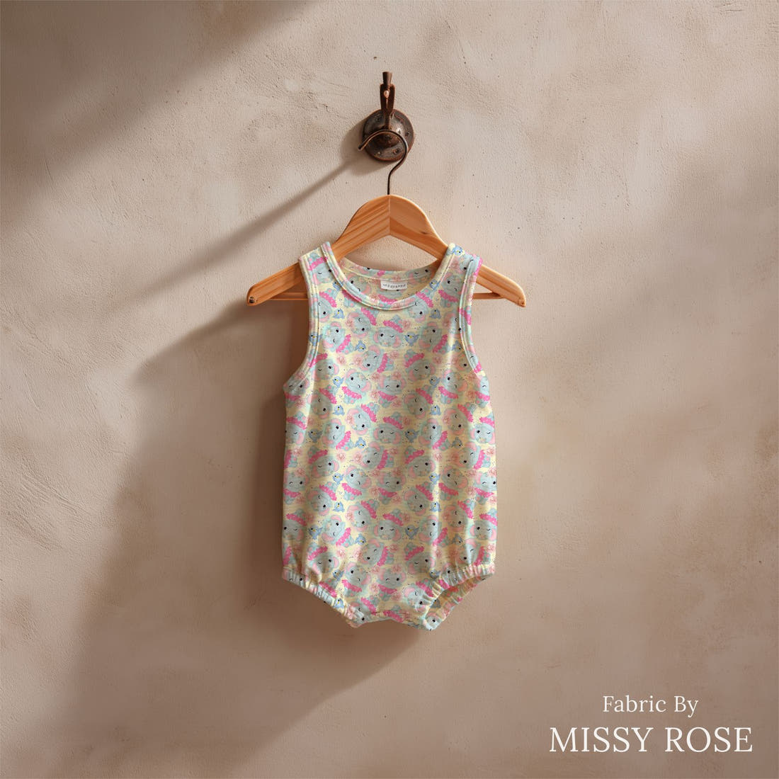 Design 1045 Yellow Elephant Fabric sewn into a baby romper – see how the print looks made up | Fabric by Missy Rose