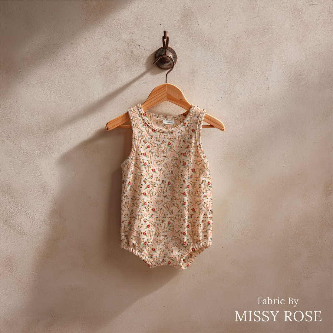 Design 1048 Giraffe Fabric sewn into a baby romper – see how the print looks made up | Fabric by Missy Rose