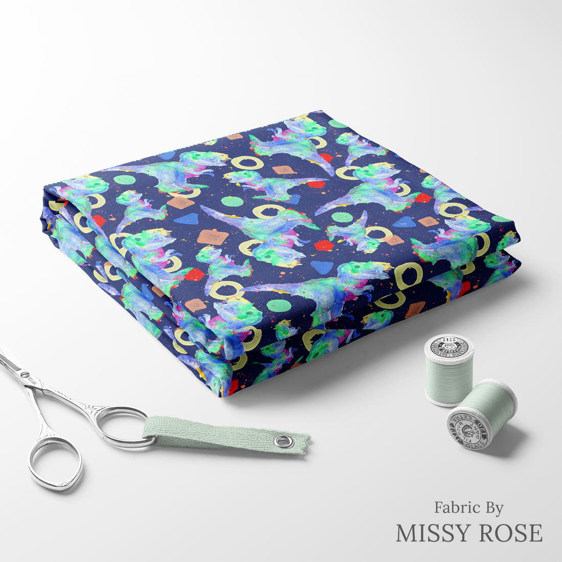 Design 1075 Watercolour Dino Fabric folded fabric stack with matching thread – pre-order fabric Australia | Fabric by Missy Rose