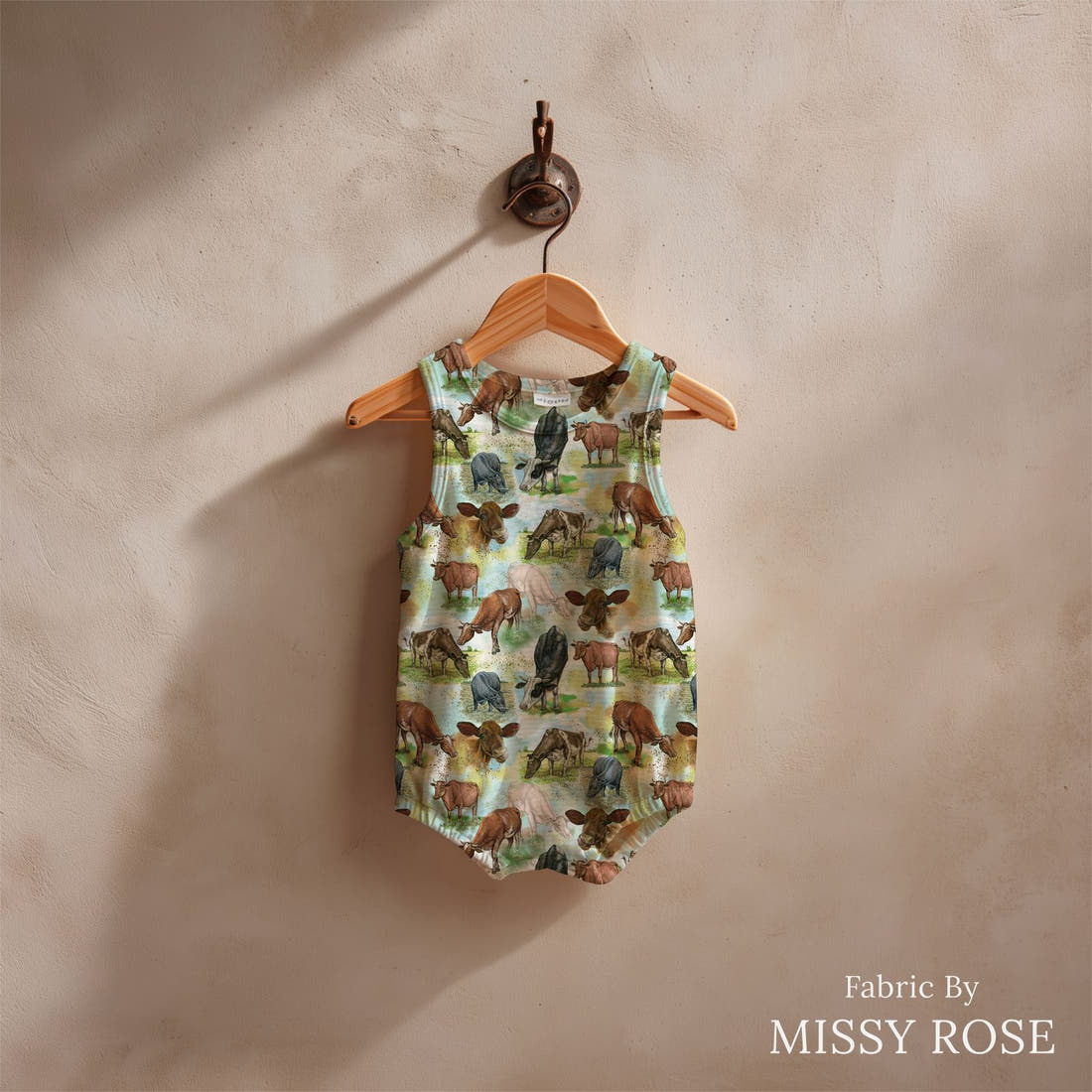 Design 1102 Blue Cow Fabric sewn into a baby romper – see how the print looks made up | Fabric by Missy Rose