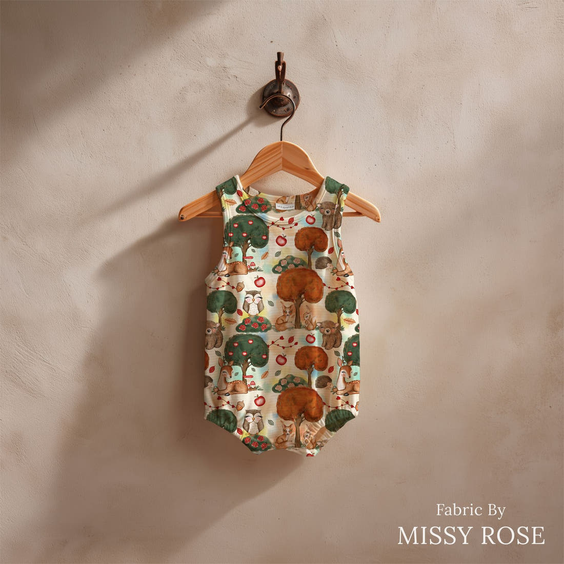 Design 1113 Woodlands Fabric sewn into a baby romper – see how the print looks made up | Fabric by Missy Rose