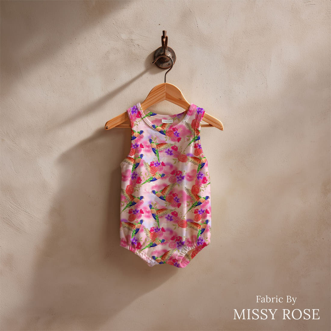 Design 1134 Lorikeet Fabric sewn into a baby romper – see how the print looks made up | Fabric by Missy Rose