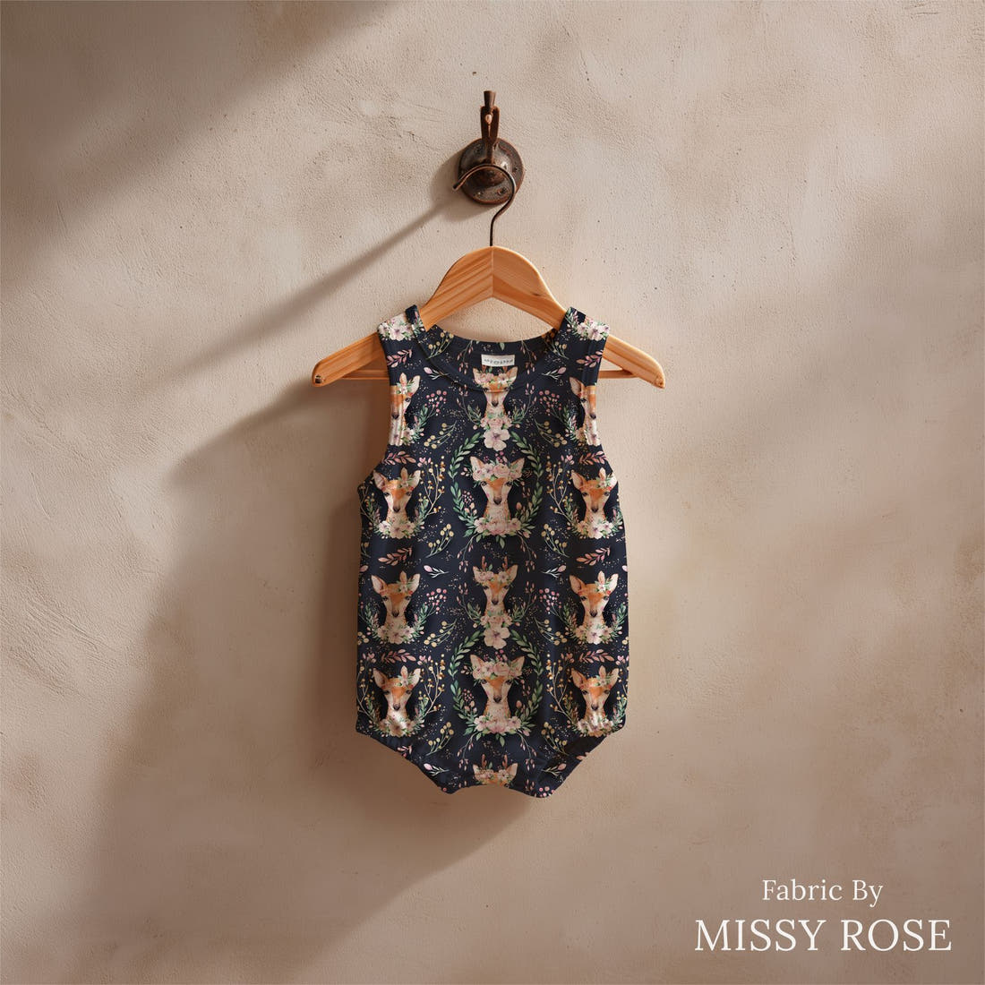 Design 1138 Navy Deer Fabric sewn into a baby romper – see how the print looks made up | Fabric by Missy Rose