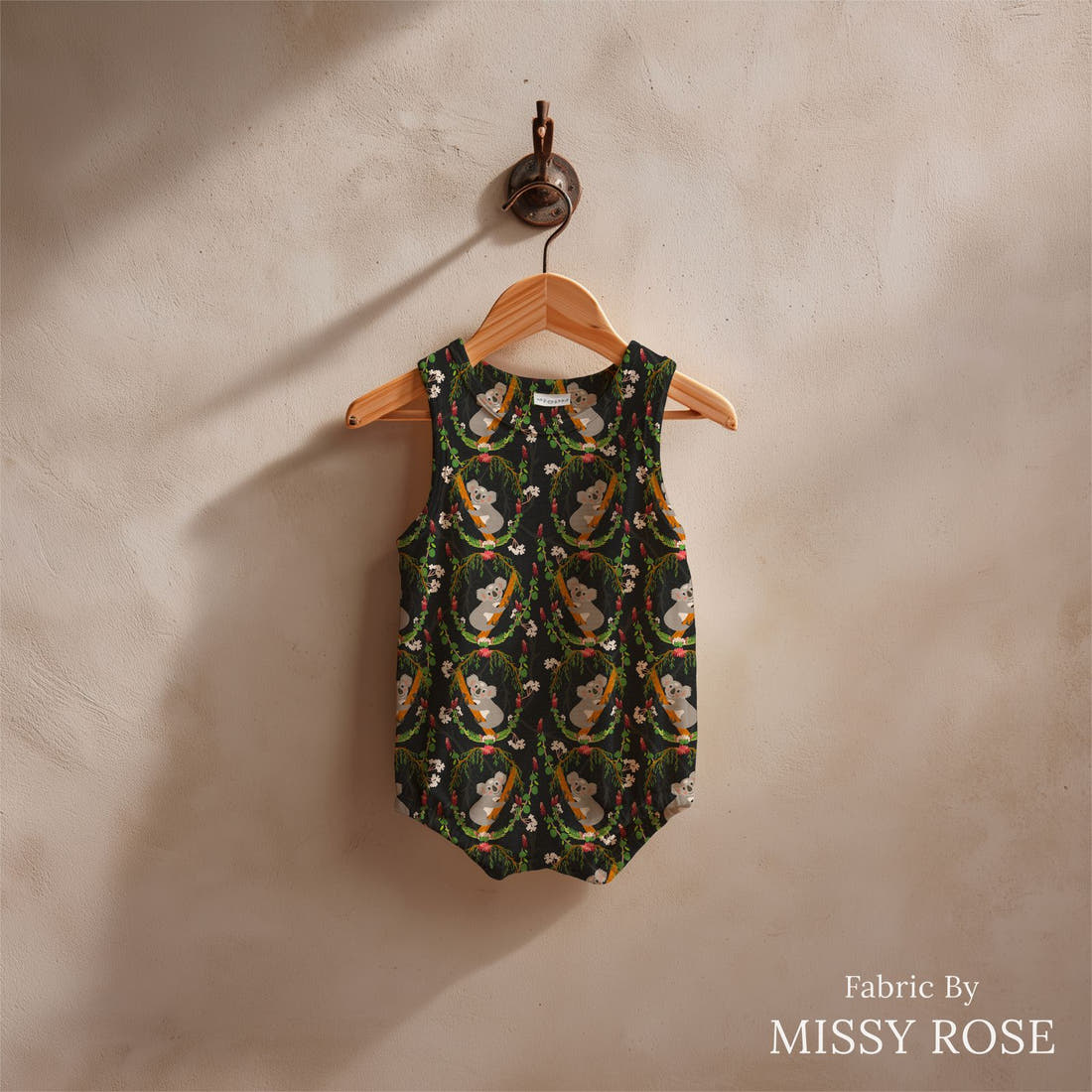 Design 1154 Black Koala Fabric sewn into a baby romper – see how the print looks made up | Fabric by Missy Rose