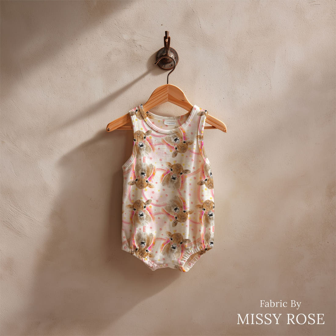 Design 169 Cute Cow Fabric sewn into a baby romper – see how the print looks made up | Fabric by Missy Rose