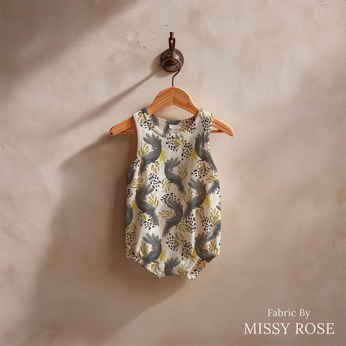 Design 179 Black Cockatoo Fabric sewn into a baby romper – see how the print looks made up | Fabric by Missy Rose