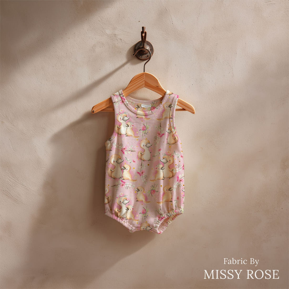 Design 470 Platypus Fabric sewn into a baby romper – see how the print looks made up | Fabric by Missy Rose