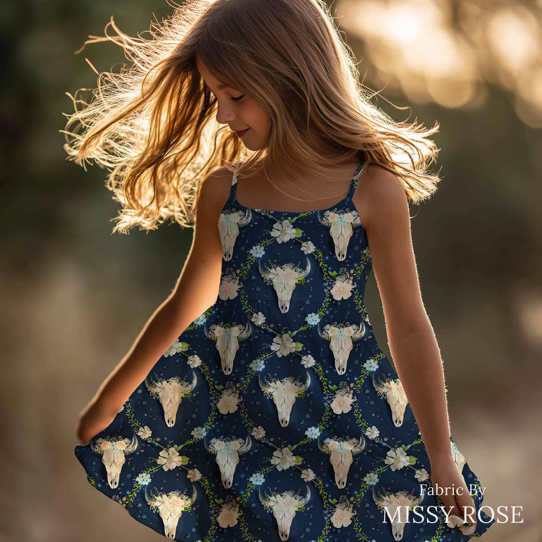 Design 580 Navy Floral Bull Skull Fabric sewn into a girls' dress – see how the print looks made up | Fabric by Missy Rose