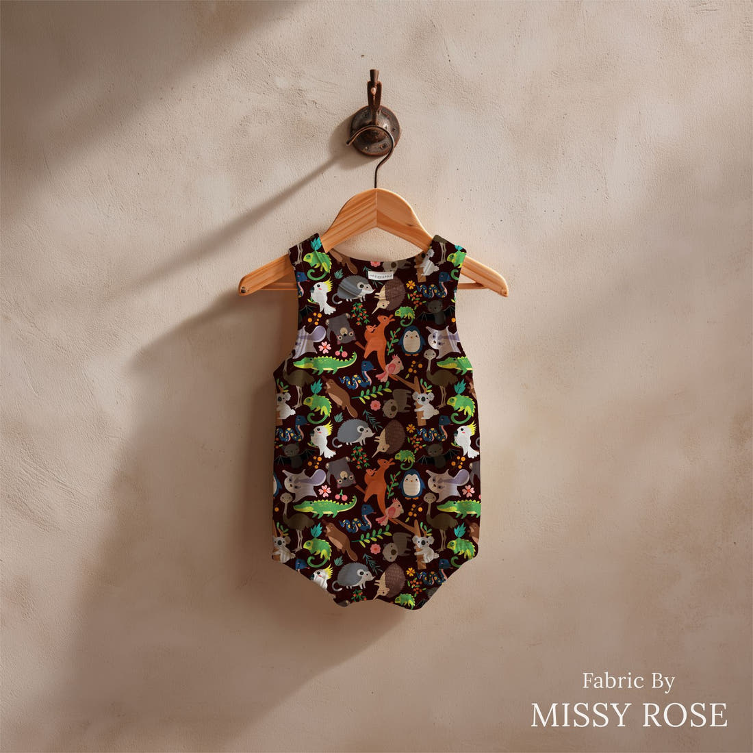 Design 590 Brown Australian Animals Fabric sewn into a baby romper – see how the print looks made up | Fabric by Missy Rose
