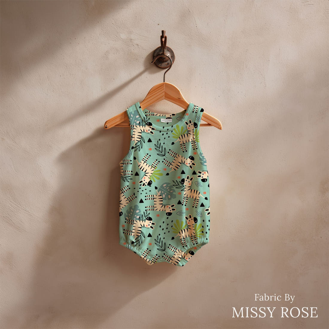Design 621 Teal Zebra Fabric sewn into a baby romper – see how the print looks made up | Fabric by Missy Rose