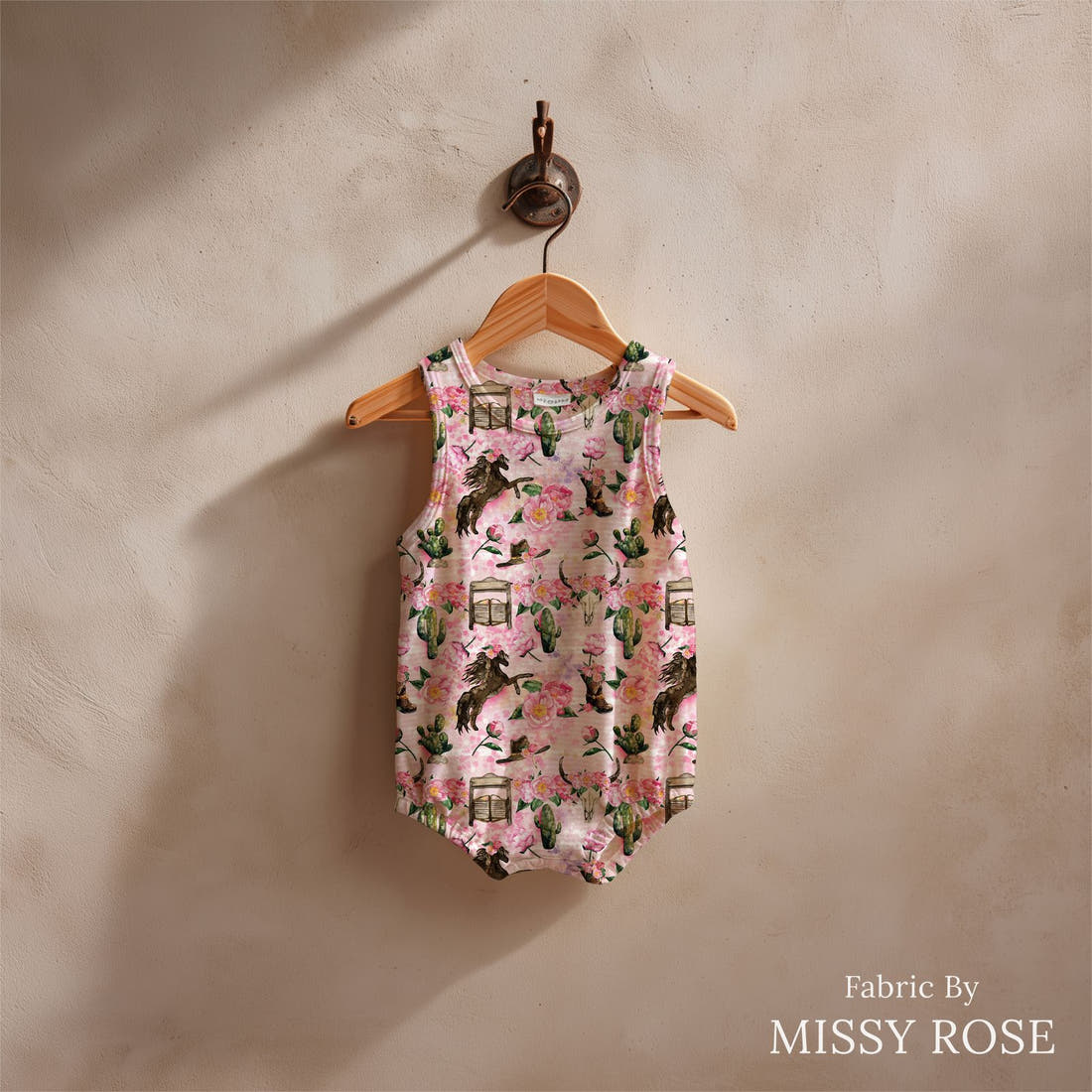 Design 645 Pink Horse Fabric sewn into a baby romper – see how the print looks made up | Fabric by Missy Rose