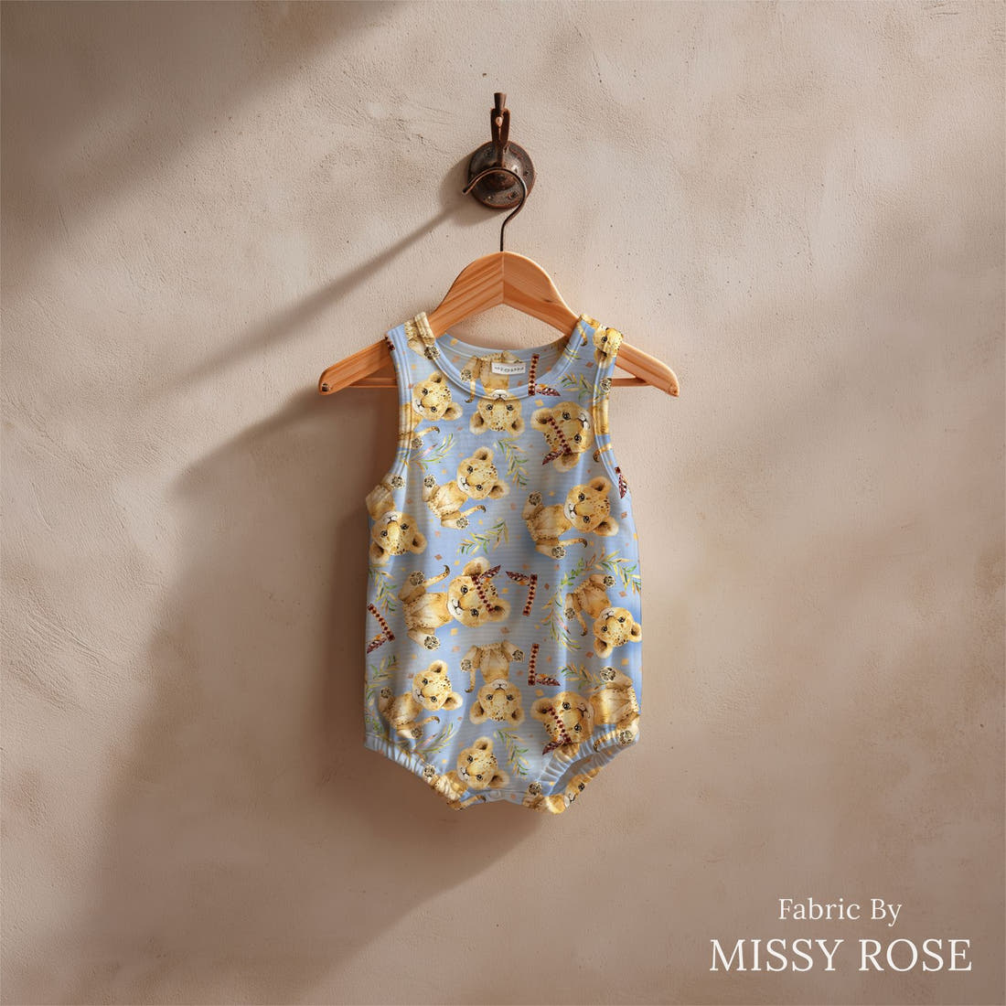 Design 693 Blue Lion Fabric sewn into a baby romper – see how the print looks made up | Fabric by Missy Rose