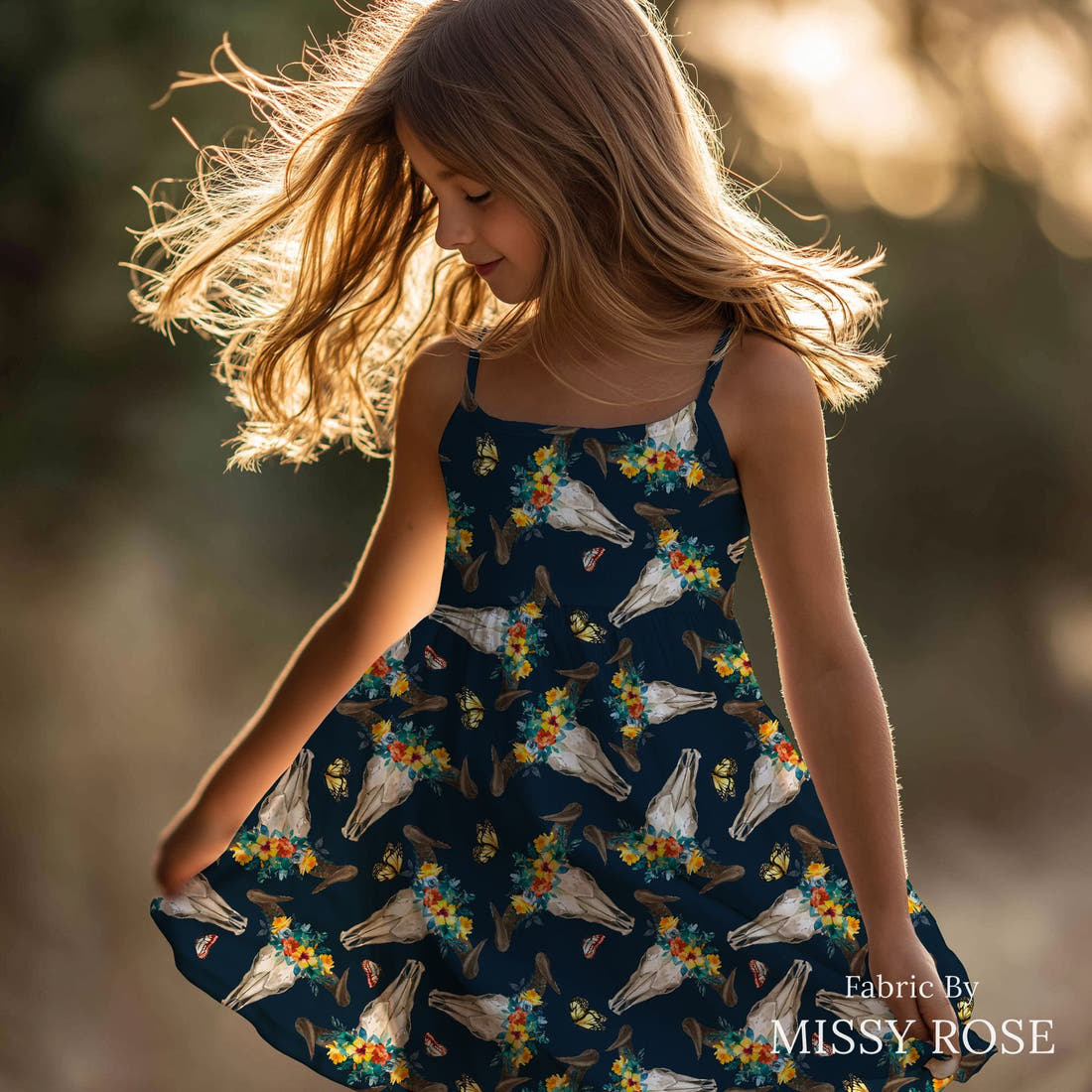 Design 811 Navy Cow Skull Fabric sewn into a girls' dress – see how the print looks made up | Fabric by Missy Rose