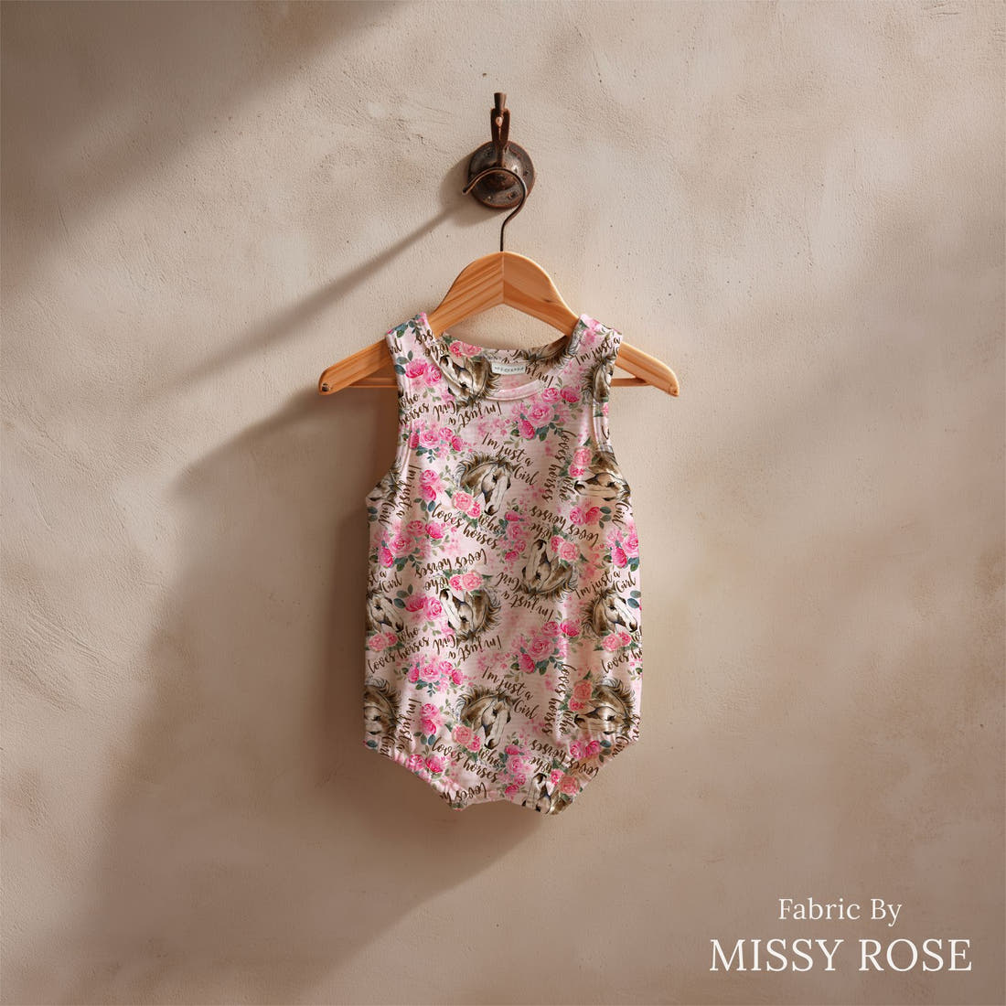 Design 822 Pink Horse Fabric sewn into a baby romper – see how the print looks made up | Fabric by Missy Rose